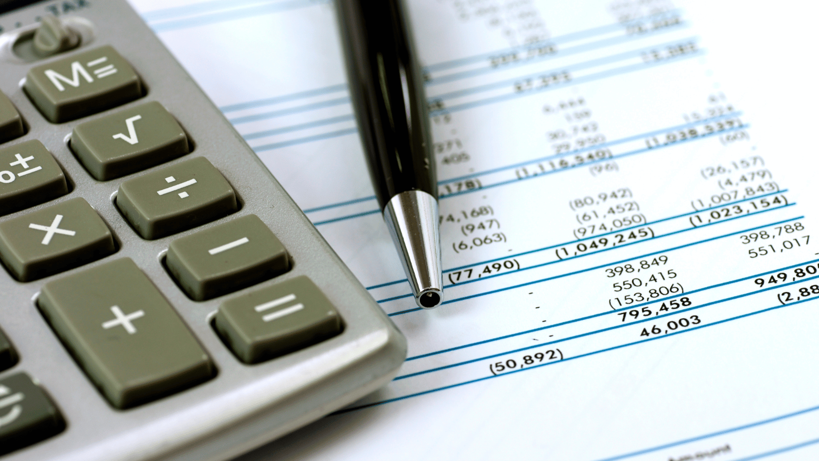calculator and pen on financial document