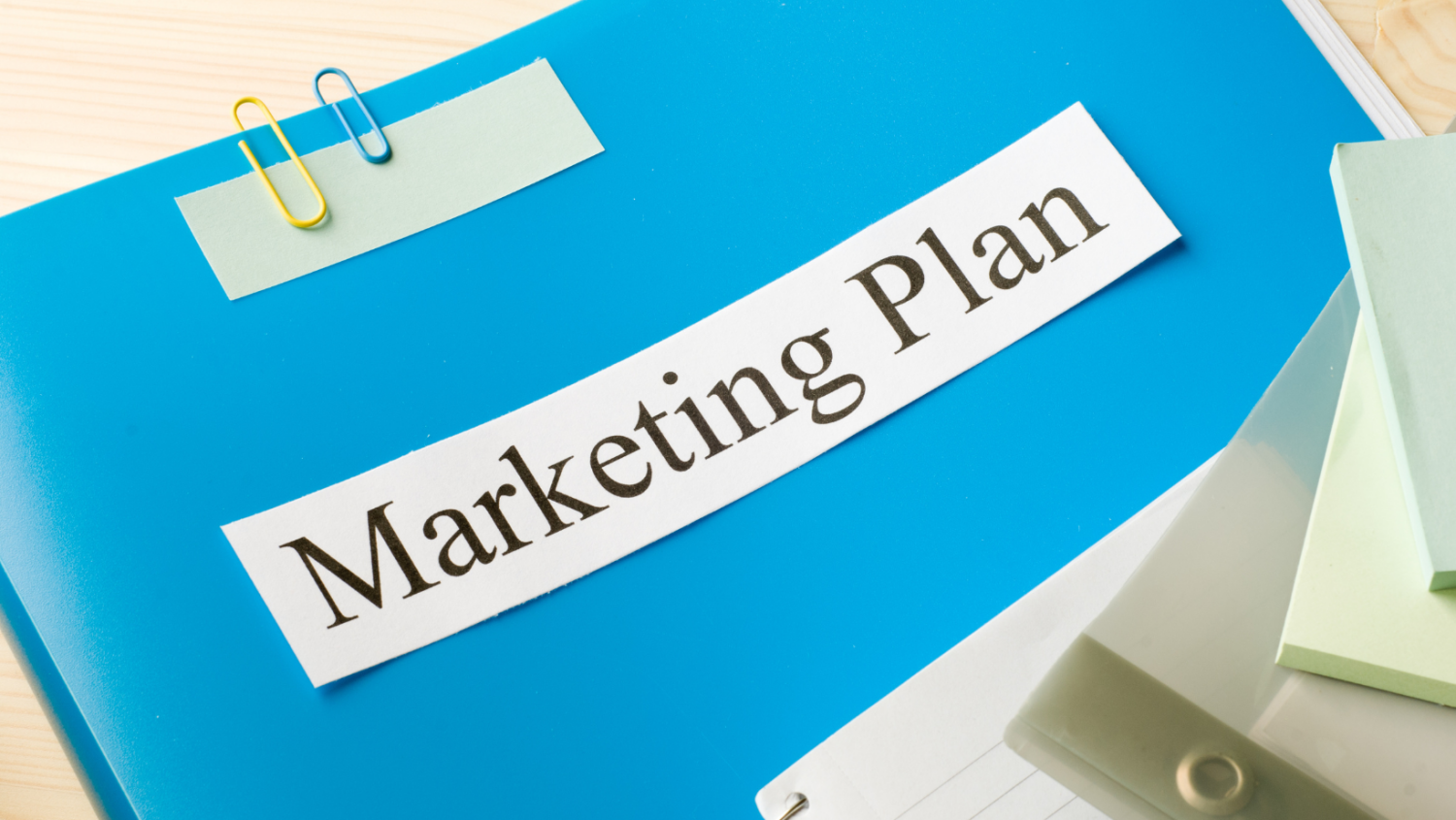 blue binder with Marketing Plan on it
