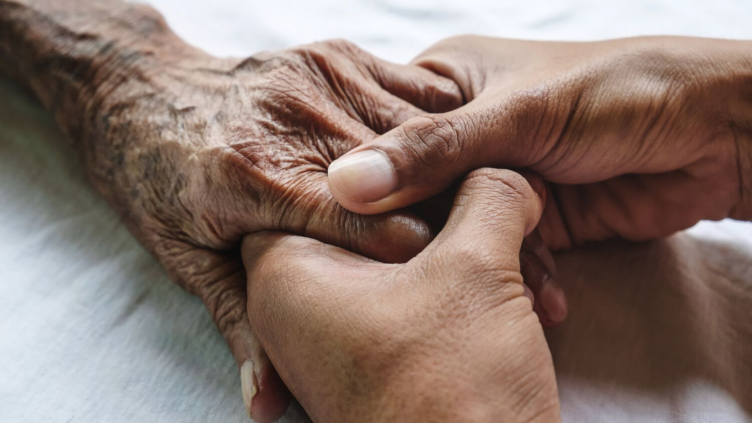 carer-holding-elderly-hand
