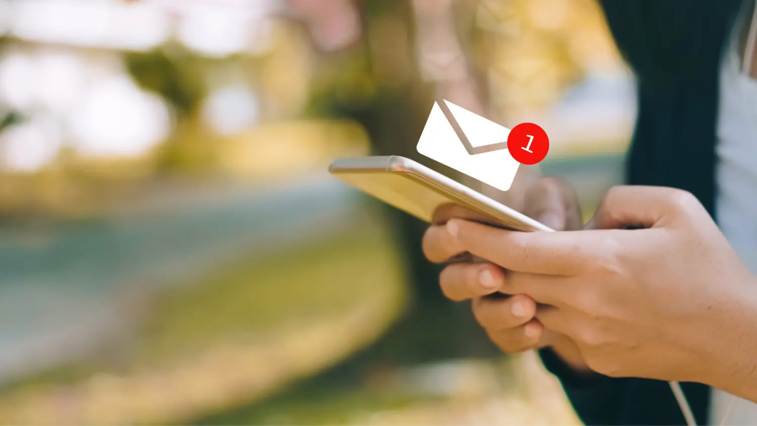 hands holding a mobile phone with email notification