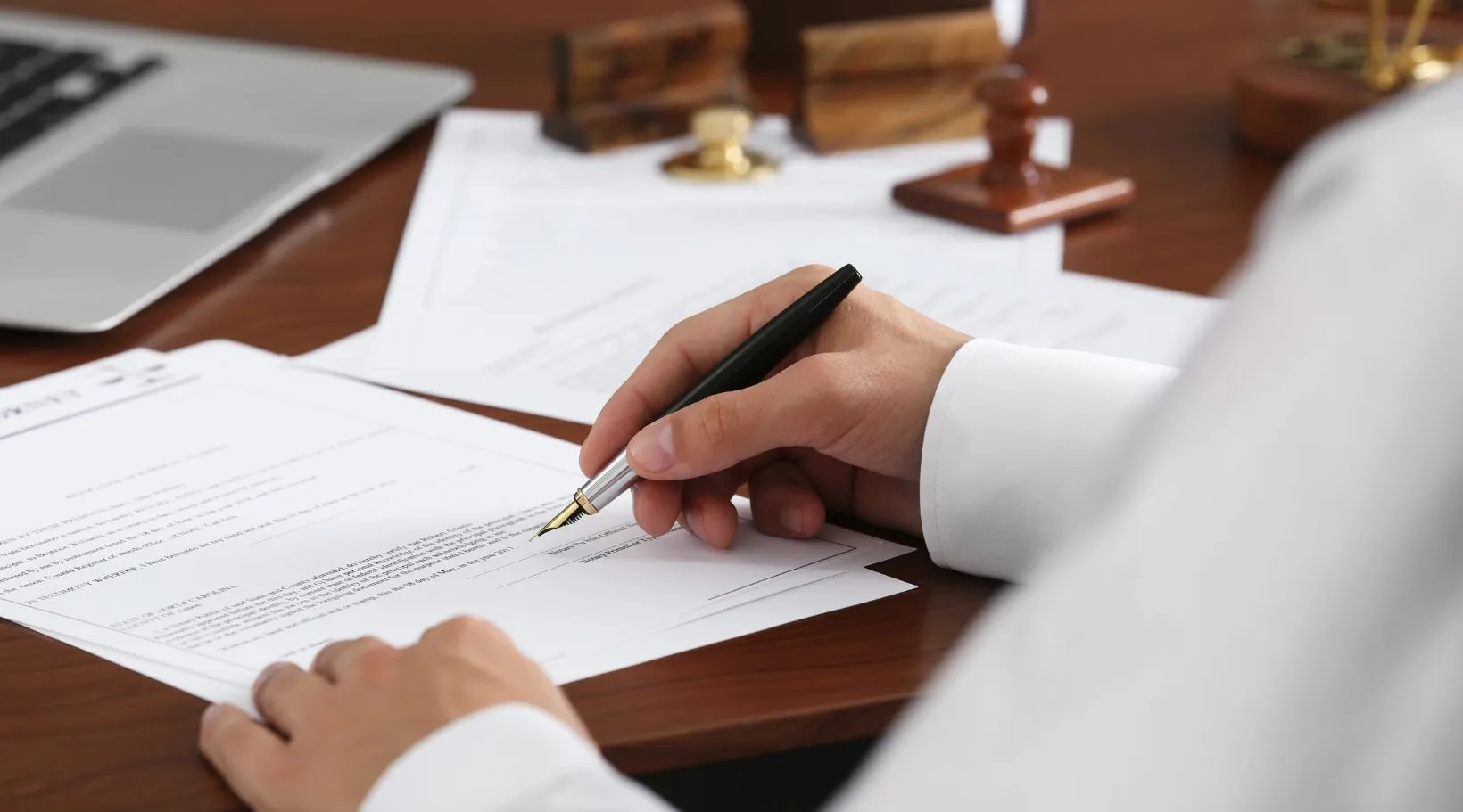 Professional signing documents to ensure business compliance with ShiftCare.