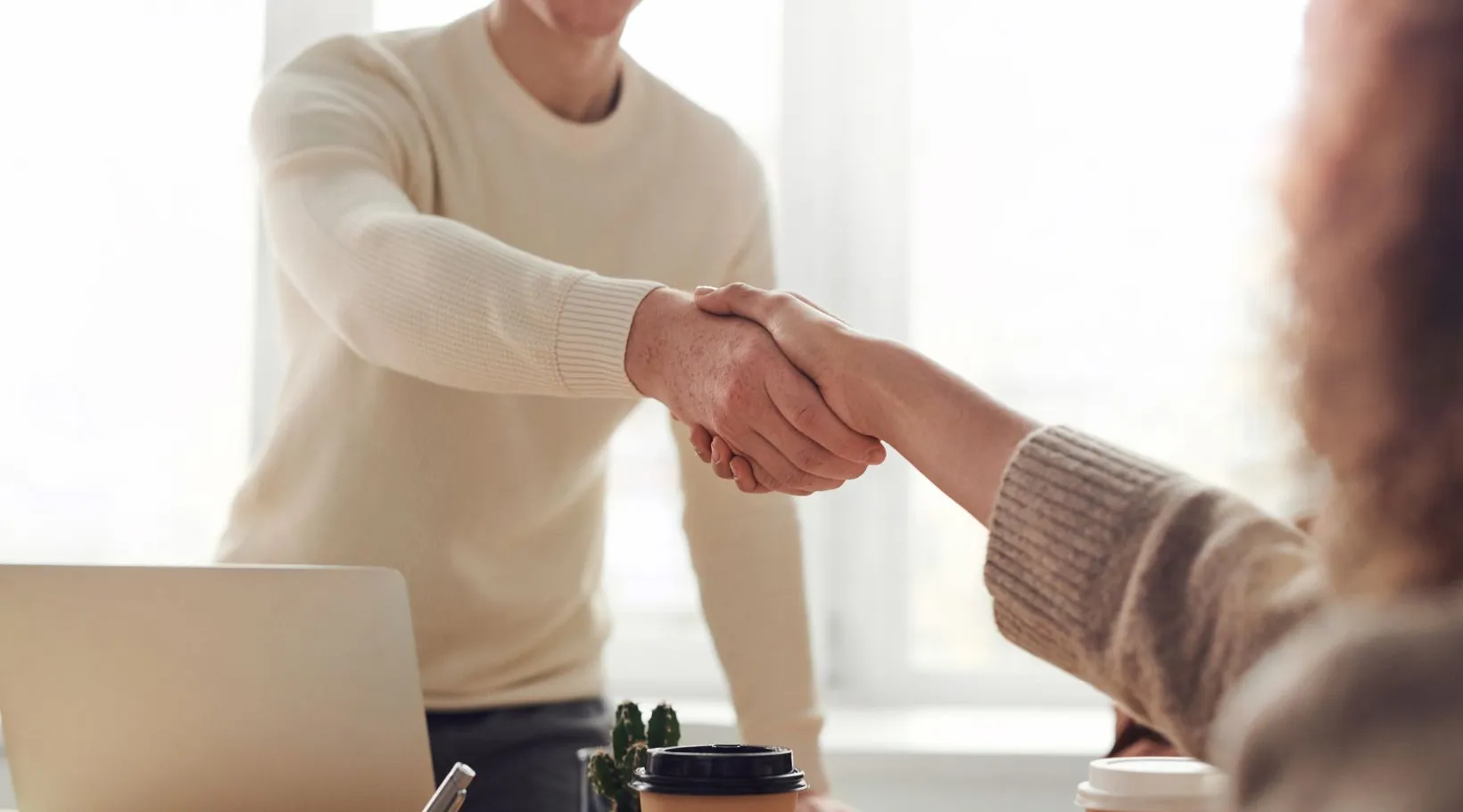 Handshake between professionals representing trust and partnership with ShiftCare.