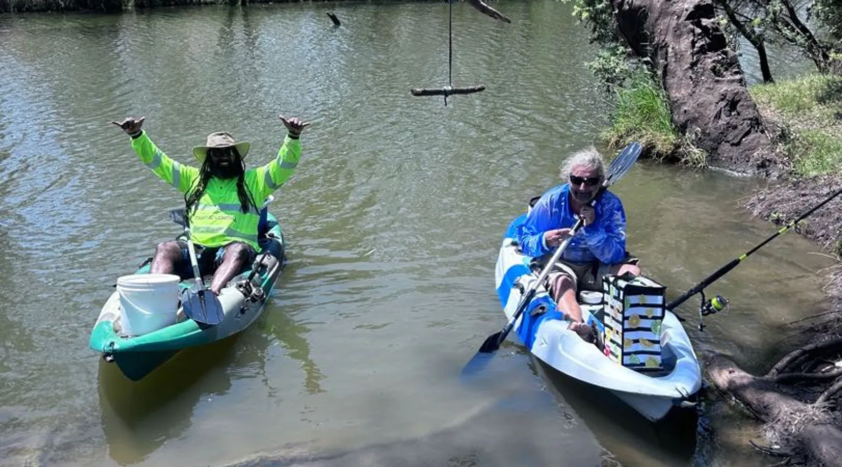 Friends enjoying kayaking and fishing in peaceful setting, ShiftCare.