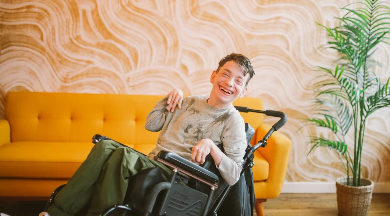 Confident student with Down syndrome attending supported education session.