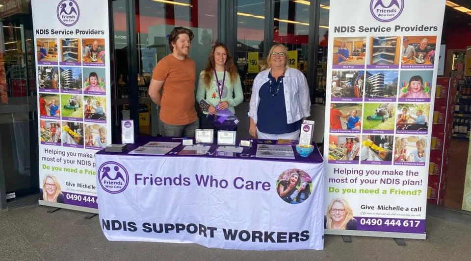 NDIS support workers promoting Friends Who Care services at community outreach event with ShiftCare.