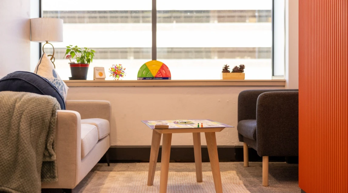 Mental health office lounge featuring board games and soft furnishings