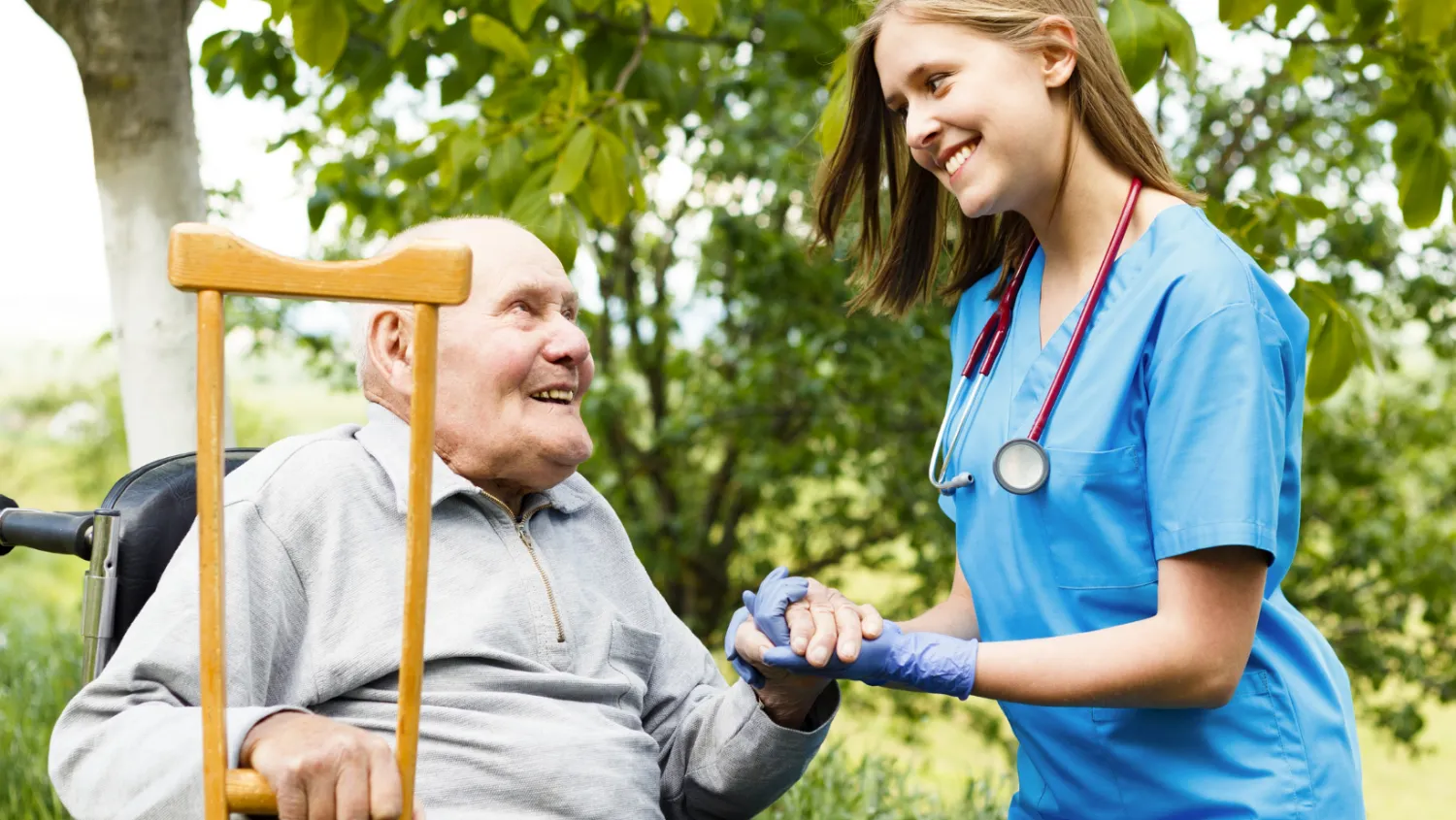 caregiver-helps-man-in-wheelchair