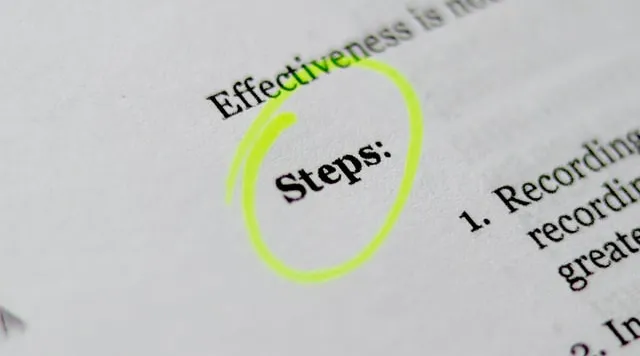 Word “Steps” highlighted in yellow on paper, symbolizing action plan or process.