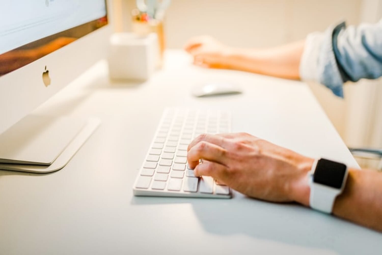 ShiftCare admin using a desktop for digital care management.