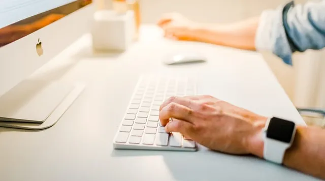 Professional typing on keyboard while using ShiftCare NDIS management system.
