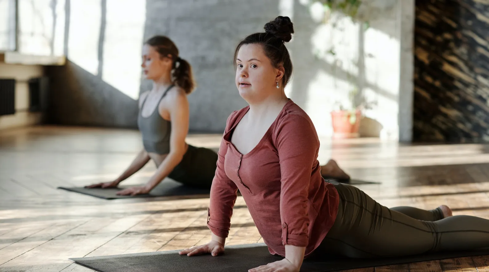 Group yoga session promoting fitness and balance for NDIS clients, ShiftCare.