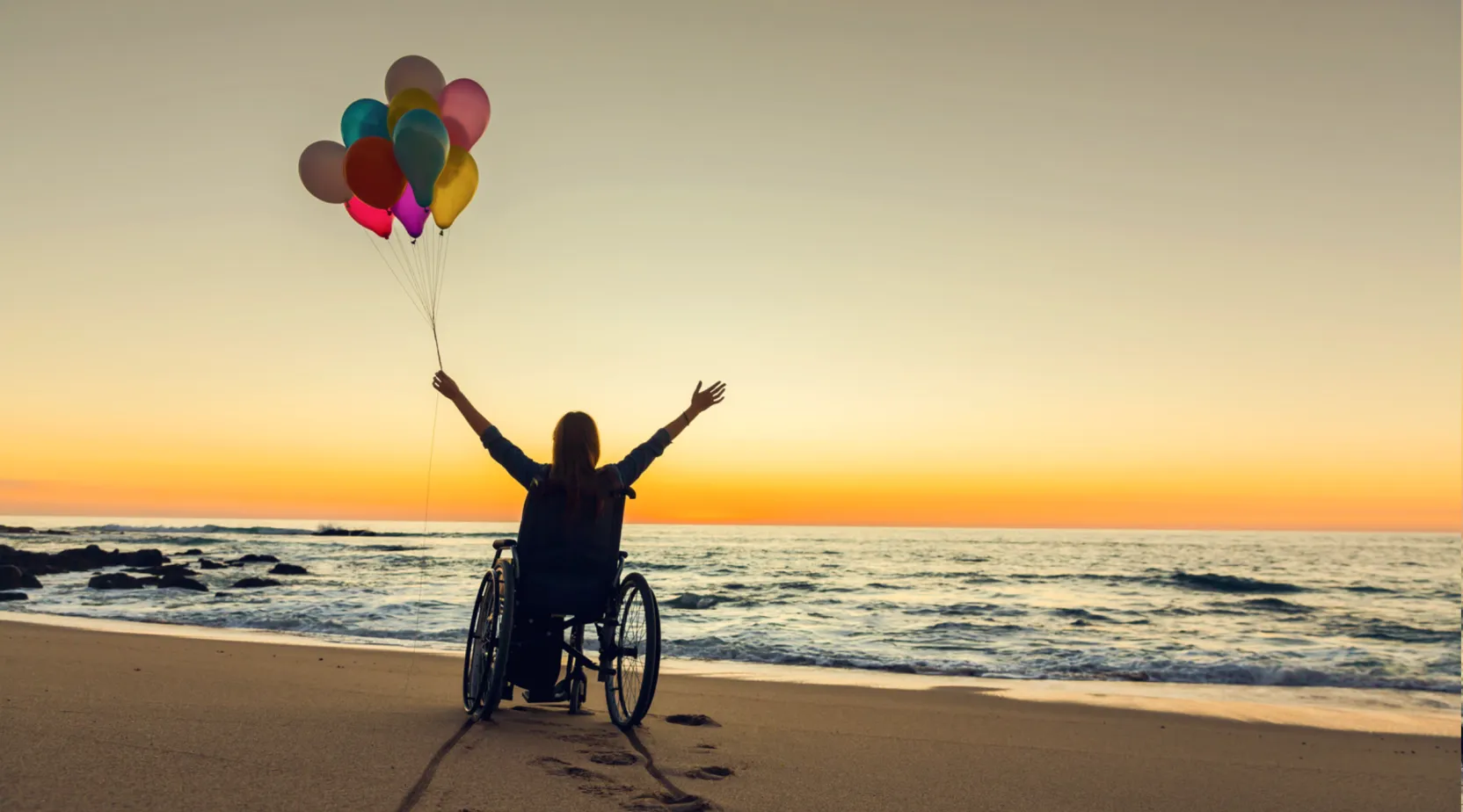 NDIS participant enjoying outdoor freedom by the beach, ShiftCare.