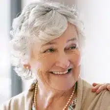 Senior woman smiling, representing the high-quality personalized home care support delivered through ShiftCare