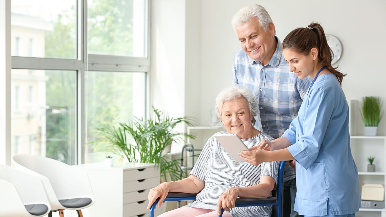 Support worker explaining home care details to senior couple using ShiftCare