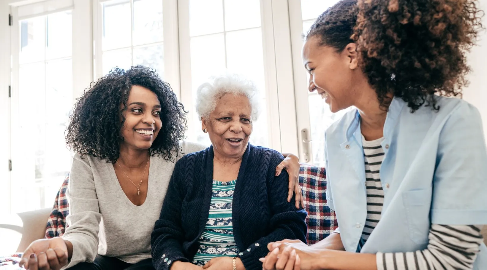 NDIS caregiver helping elderly client with family support, ShiftCare.