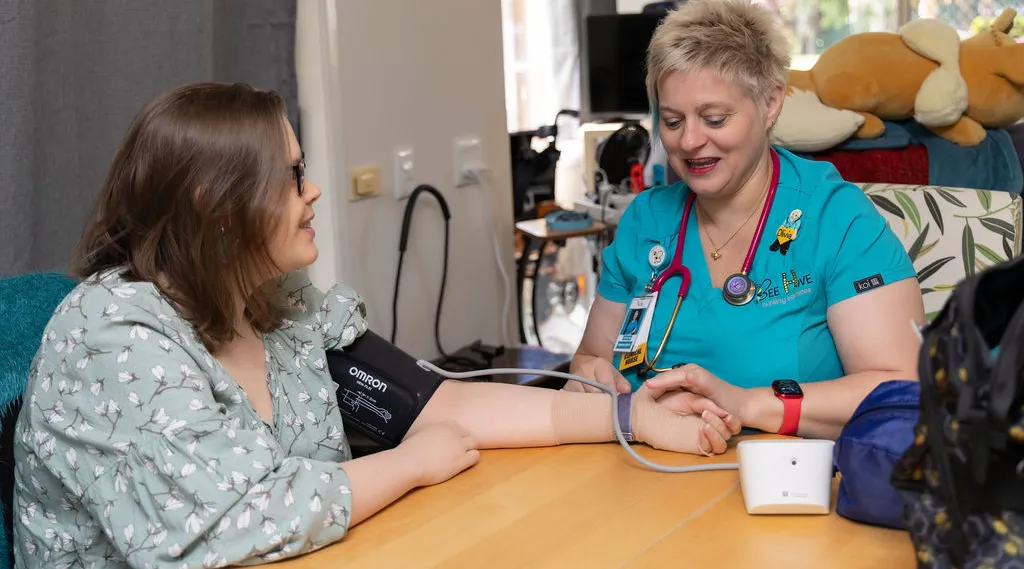Nurse checking blood pressure during home visit, ShiftCare.