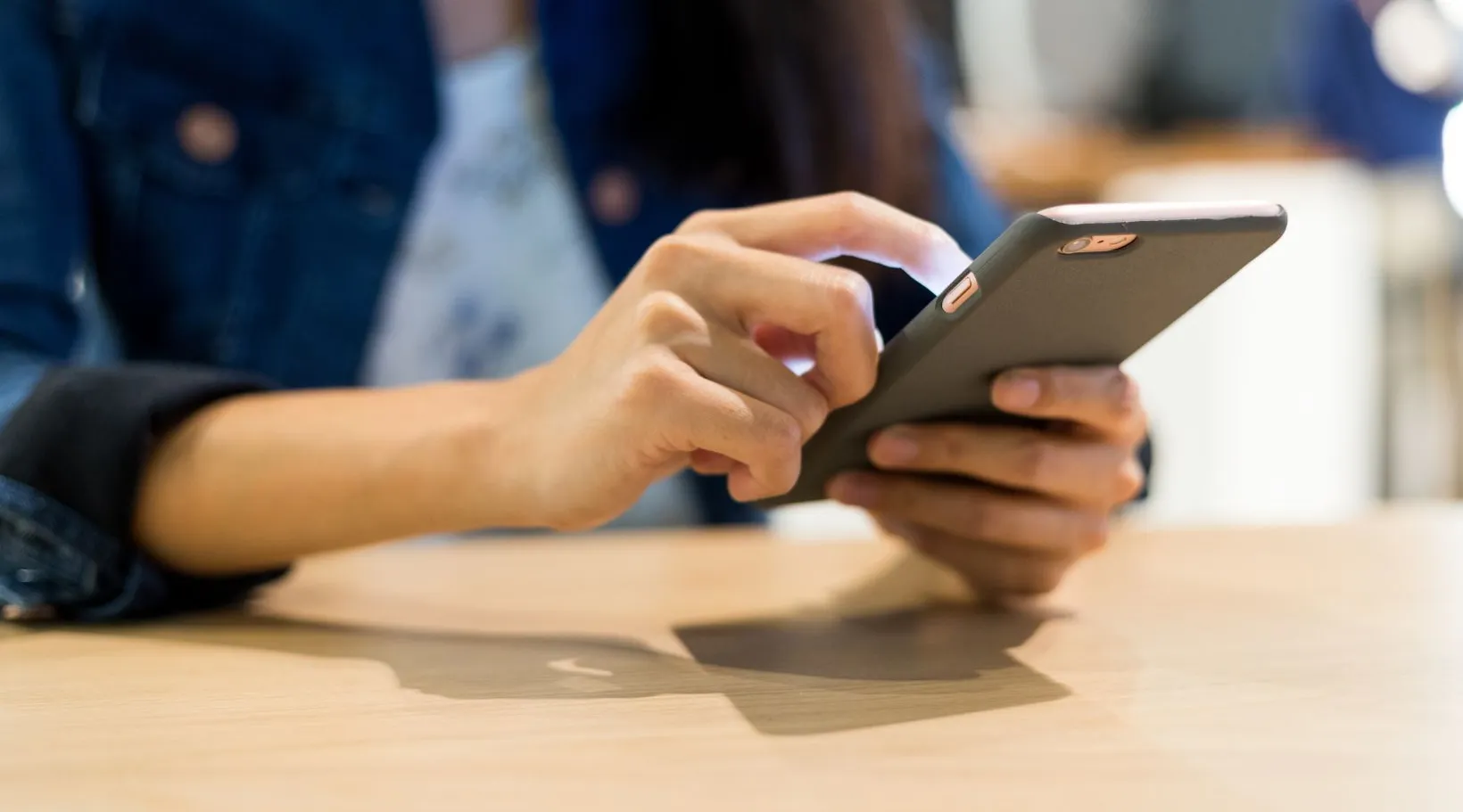 Mobile phone used by care staff to manage schedules and updates in ShiftCare home care software.