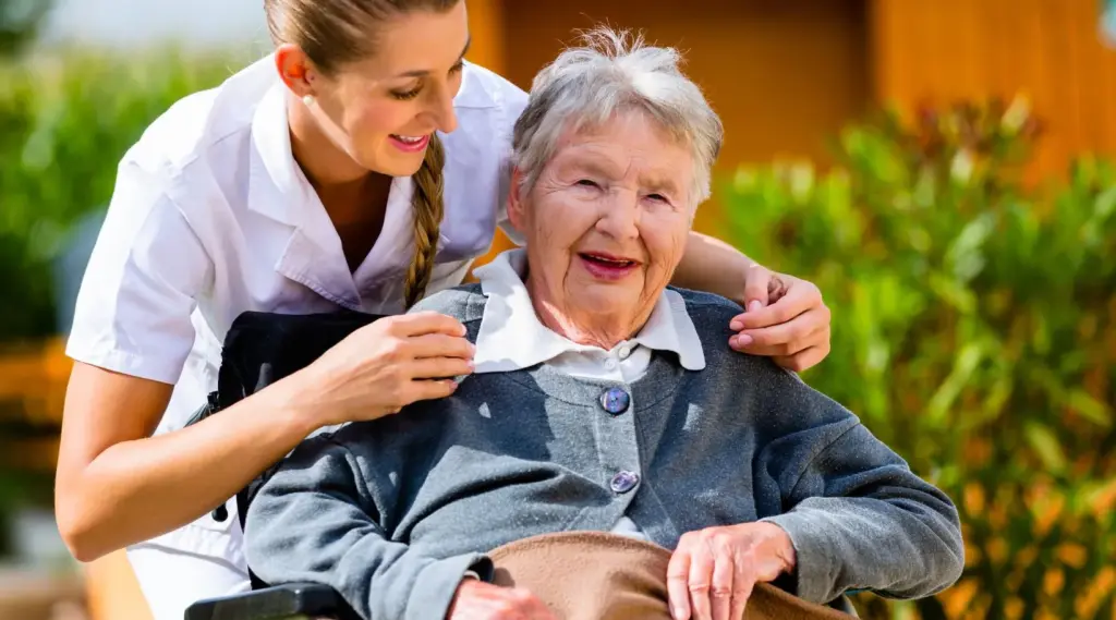 ShiftCare caregiver supporting an elderly client outdoors with compassionate home care.