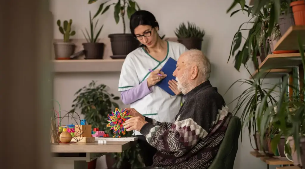 Caregiver assisting elderly client with daily home-care needs, ShiftCare.