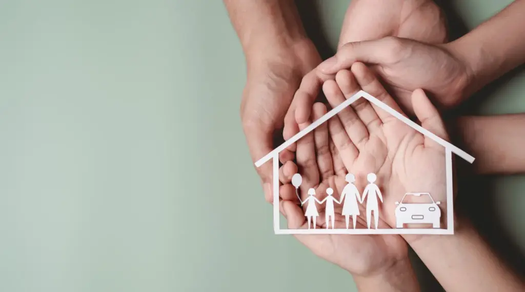 Hands protecting family and home symbolizing supportive home care services for families.
