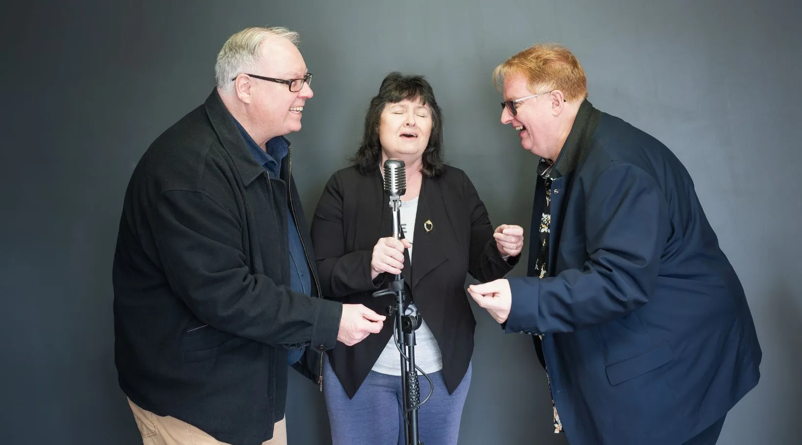 Adults singing together during group activity for disability services, ShiftCare.