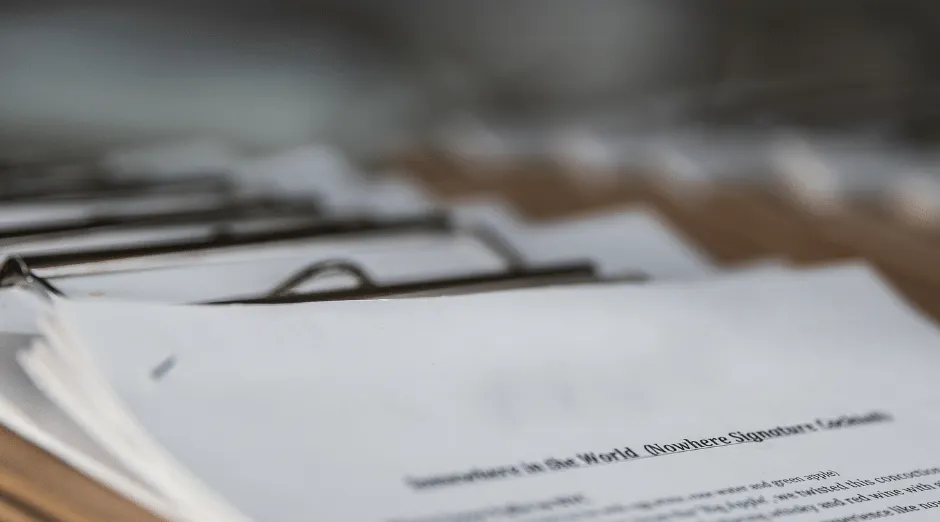 Organized client forms on clipboard showing ShiftCare’s secure document management.