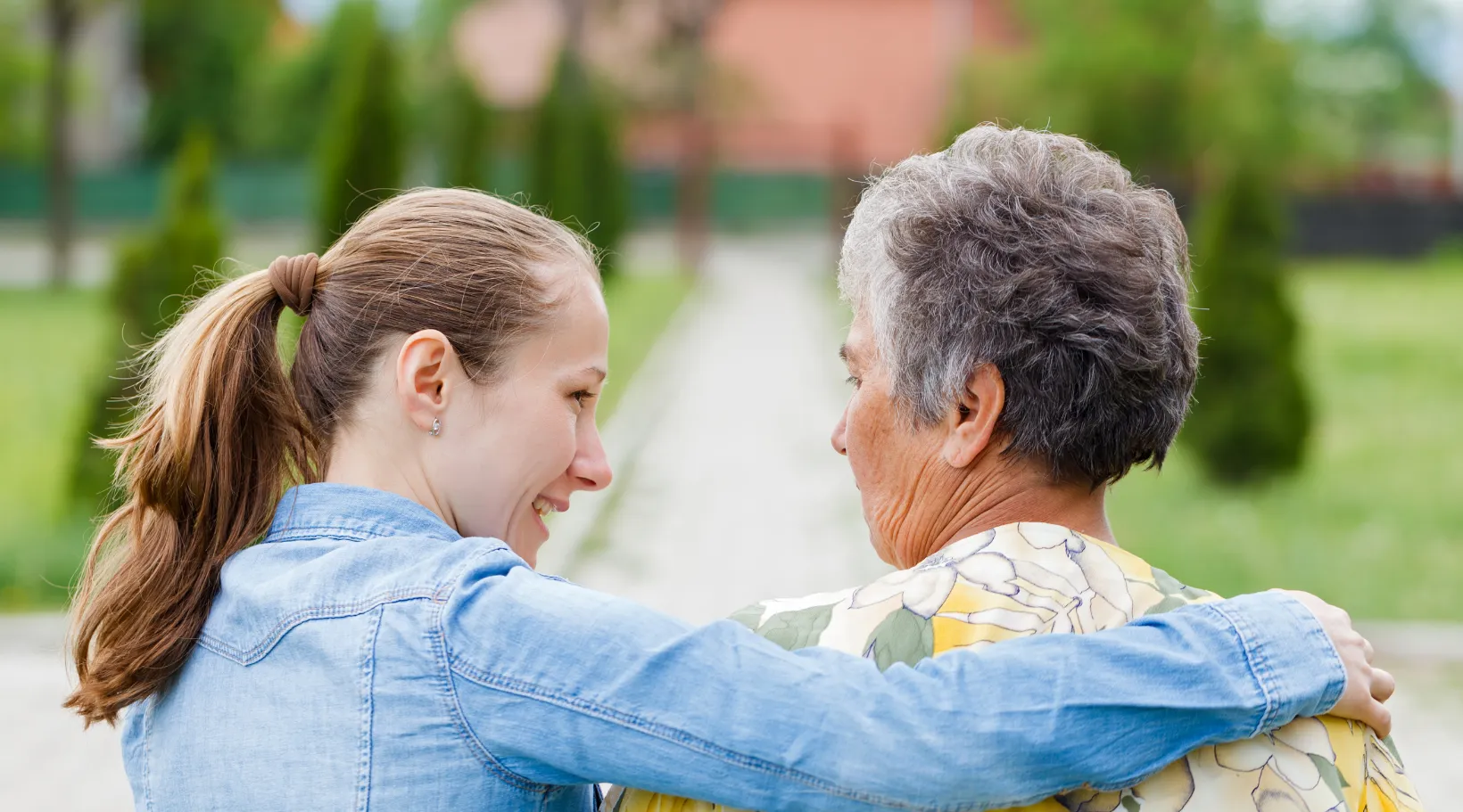 ShiftCare concept showing caregiver supporting elderly client.