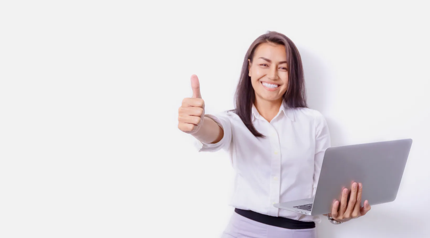 Confident professional giving thumbs up with laptop, symbolizing success with ShiftCare.