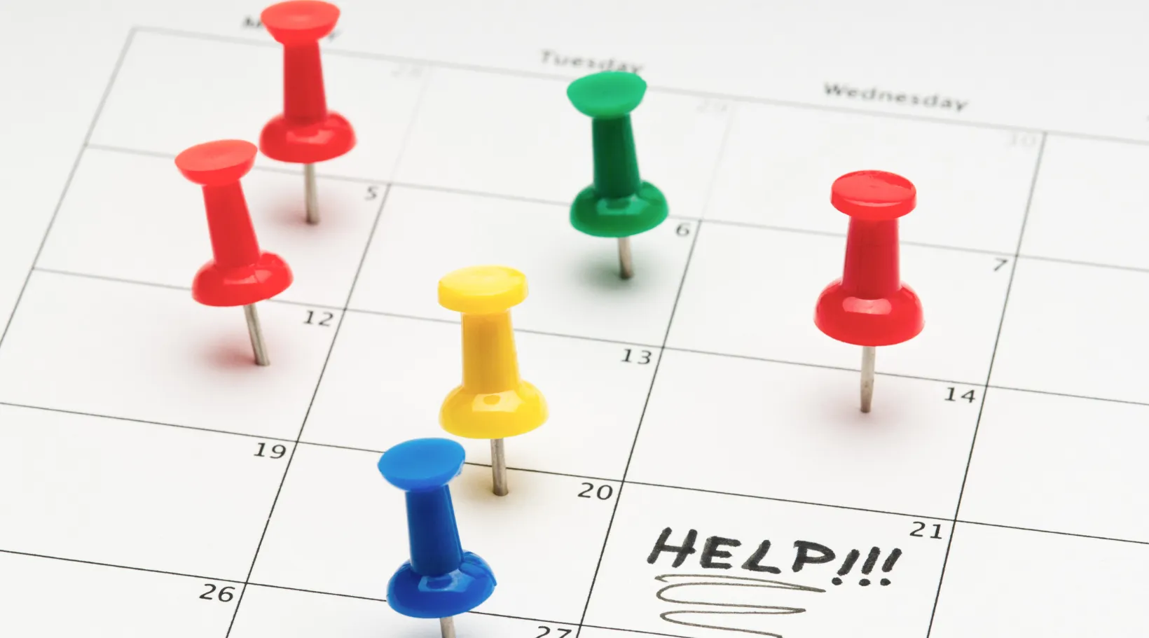 Calendar with color pins representing workload stress and scheduling challenges, ShiftCare.