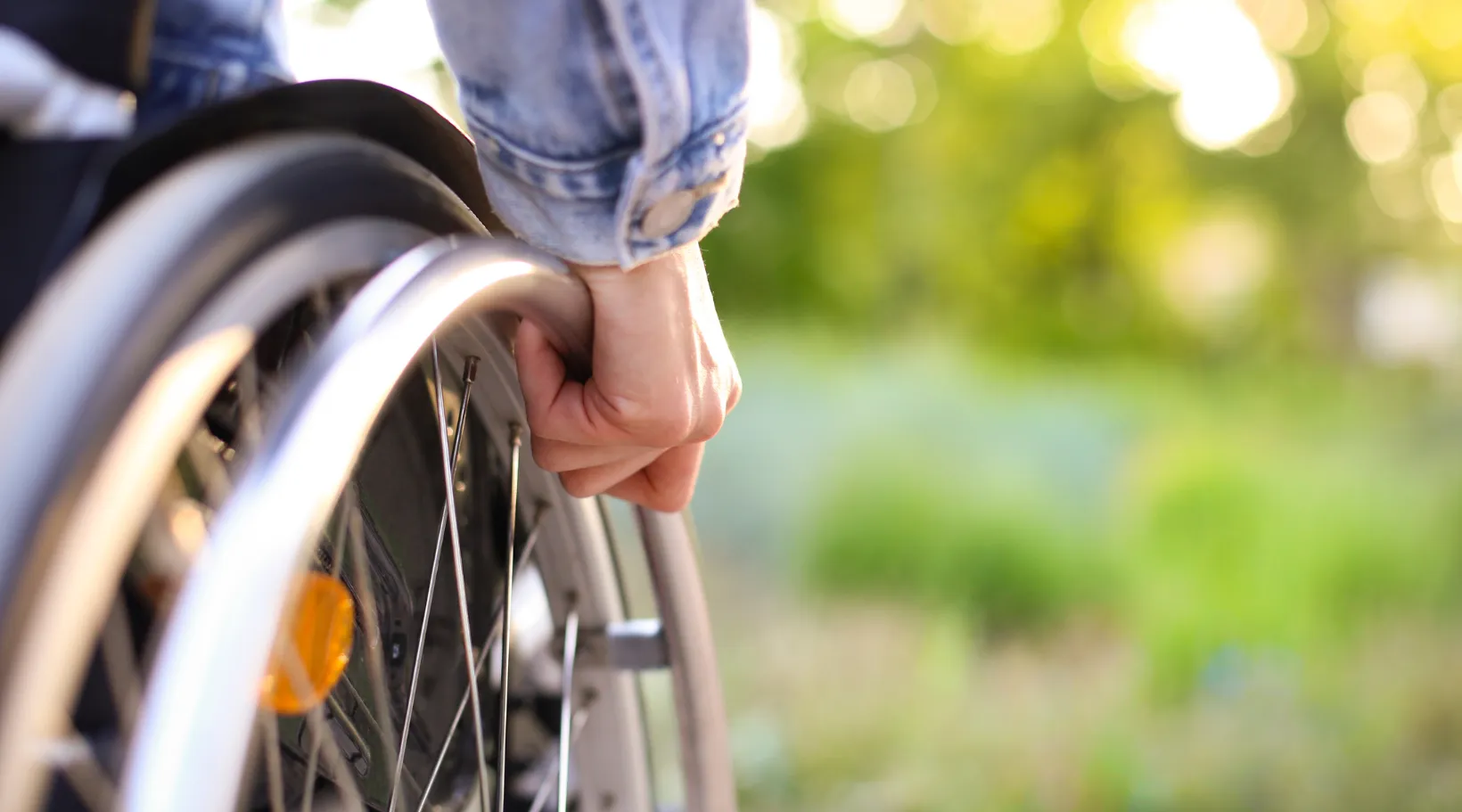 Person in wheelchair outdoors representing accessibility and independence with ShiftCare.