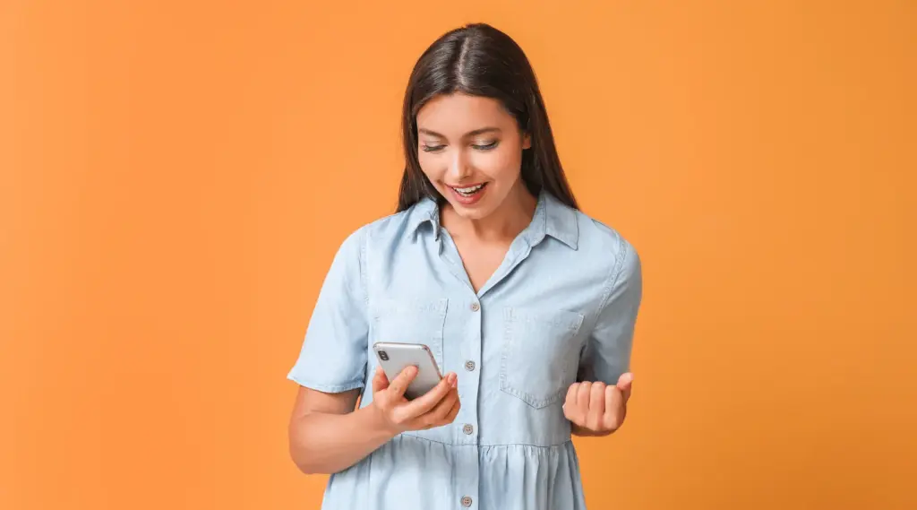 Care provider celebrating after completing tasks efficiently using the ShiftCare mobile app.