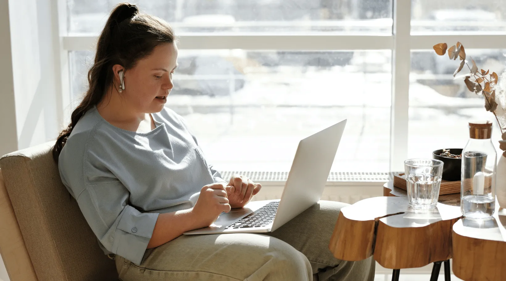 NDIS participant engaged in online learning or remote work, ShiftCare.