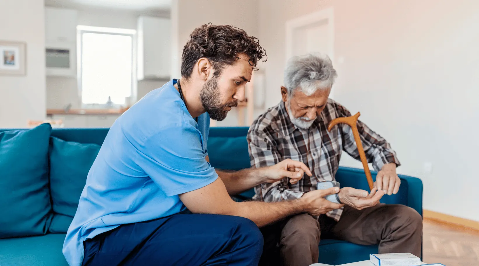 ShiftCare caregiver assisting elderly man with medication management during home care visit.