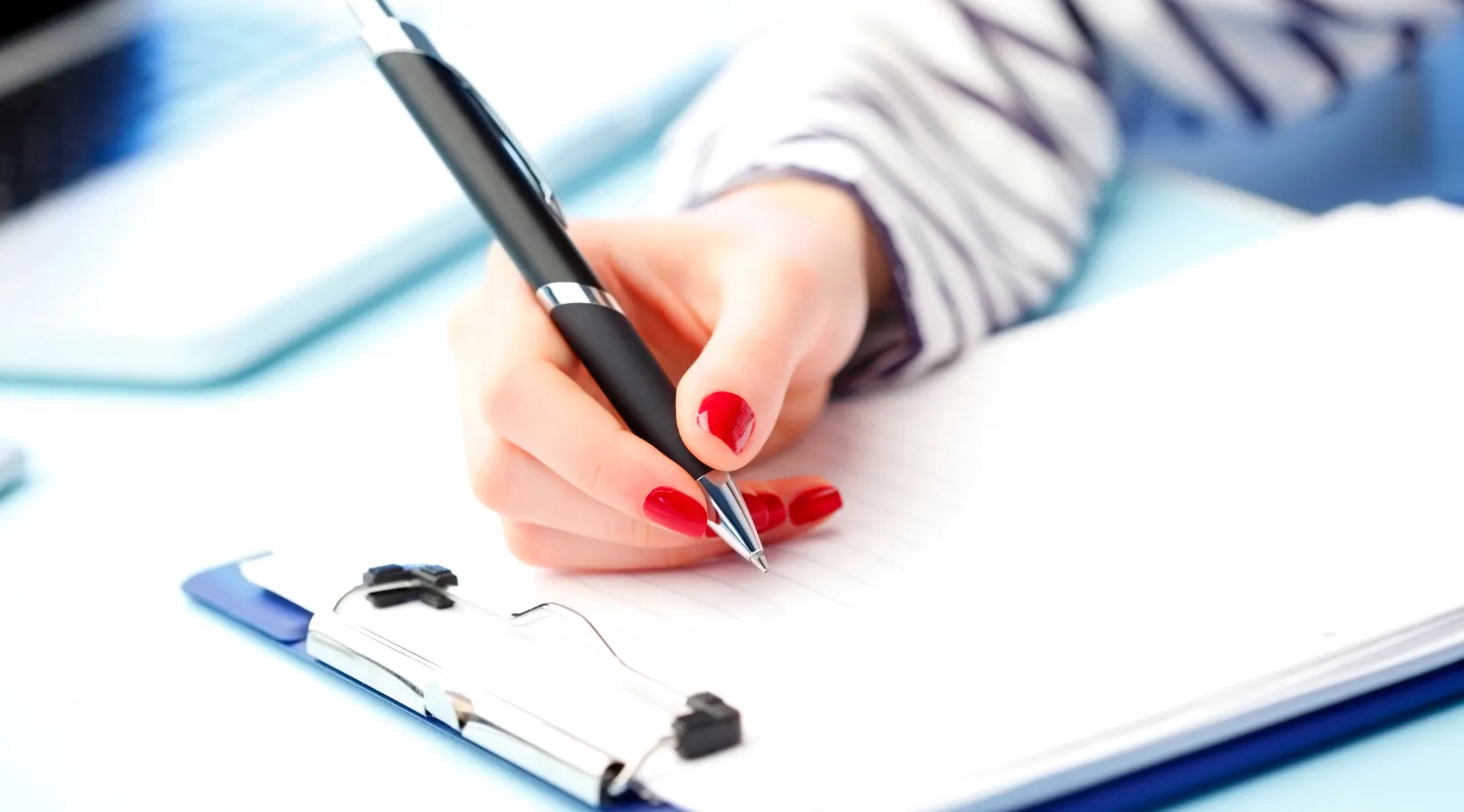 Close-up of clipboard note-taking for care records, ShiftCare.