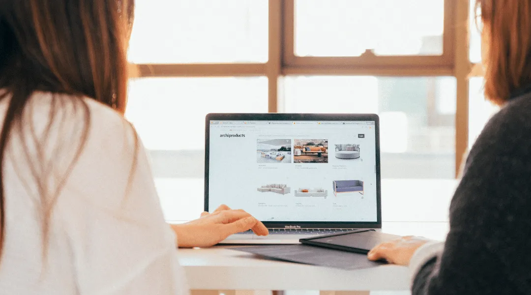 Two team members reviewing digital content on a laptop, symbolizing ShiftCare’s smart care coordination tools.