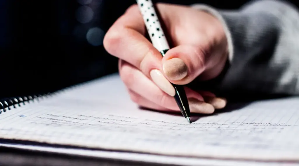 Care administrator writing notes and documenting client records in workflows supported by ShiftCare.