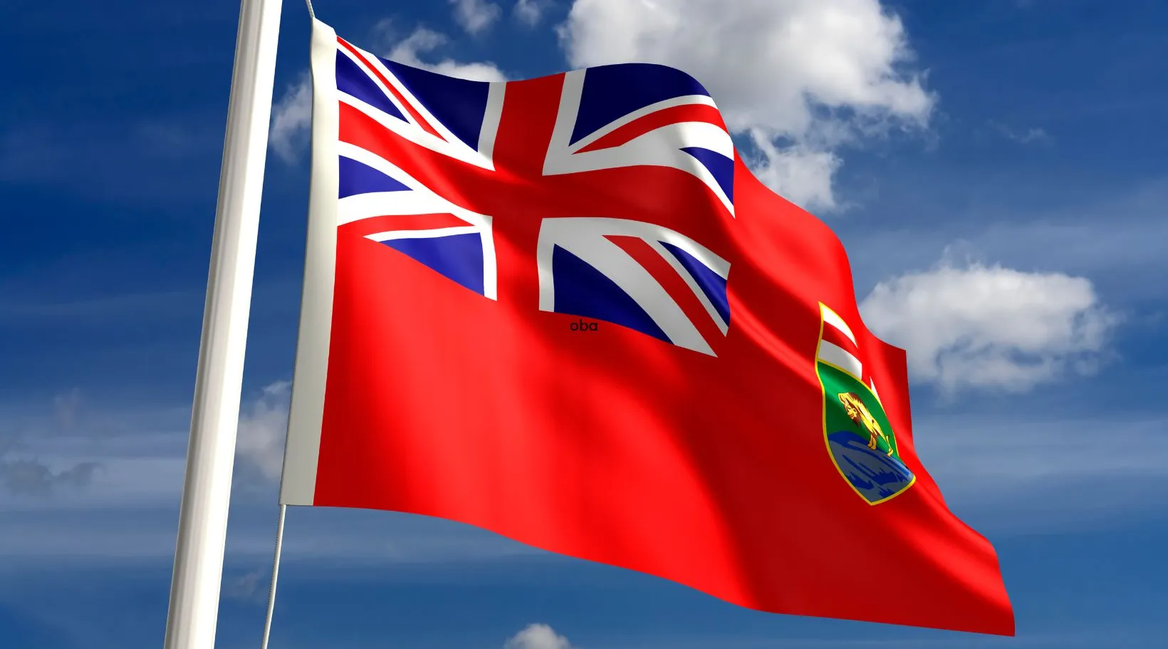 Close-up of the Manitoba flag flying on a flagpole under bright cloudy skies.Shiftcare