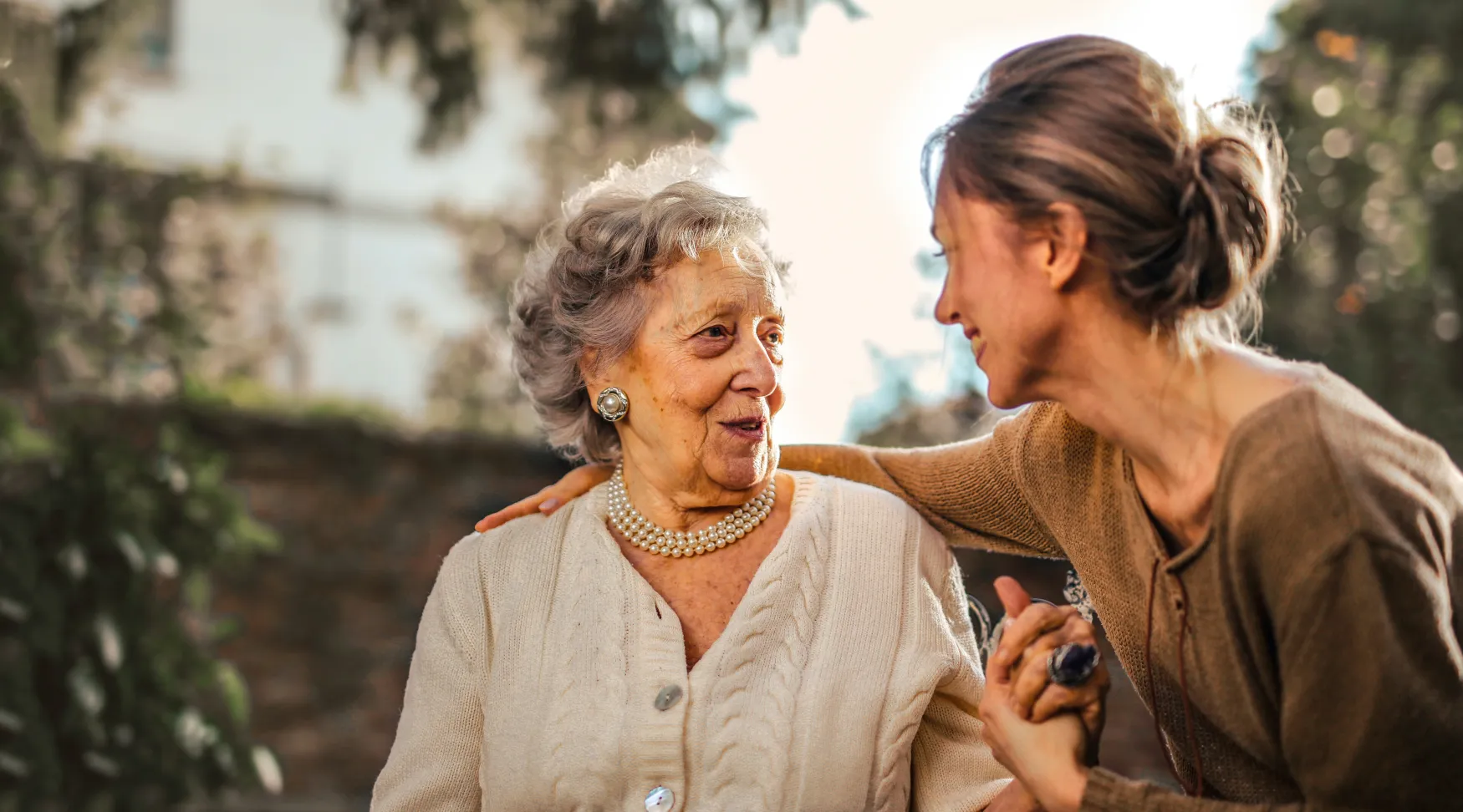 Caregiver offering comfort and kindness to elderly client, ShiftCare.