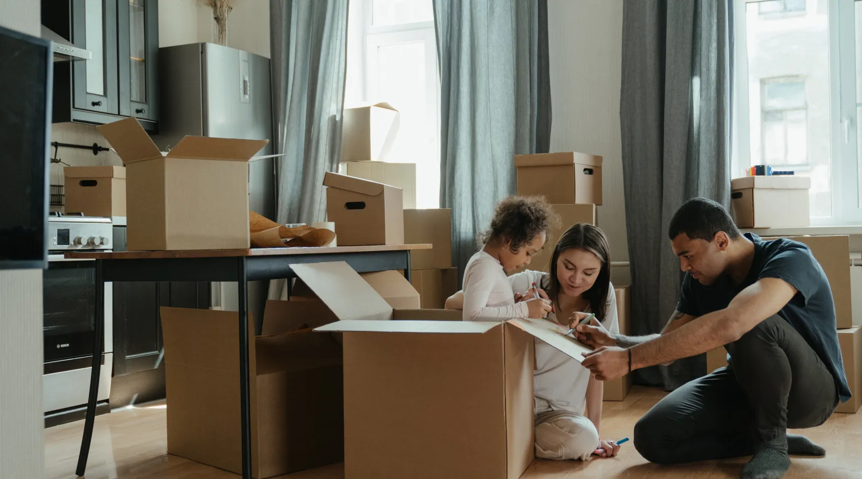 Family preparing to move into new home, supported by ShiftCare home care services.