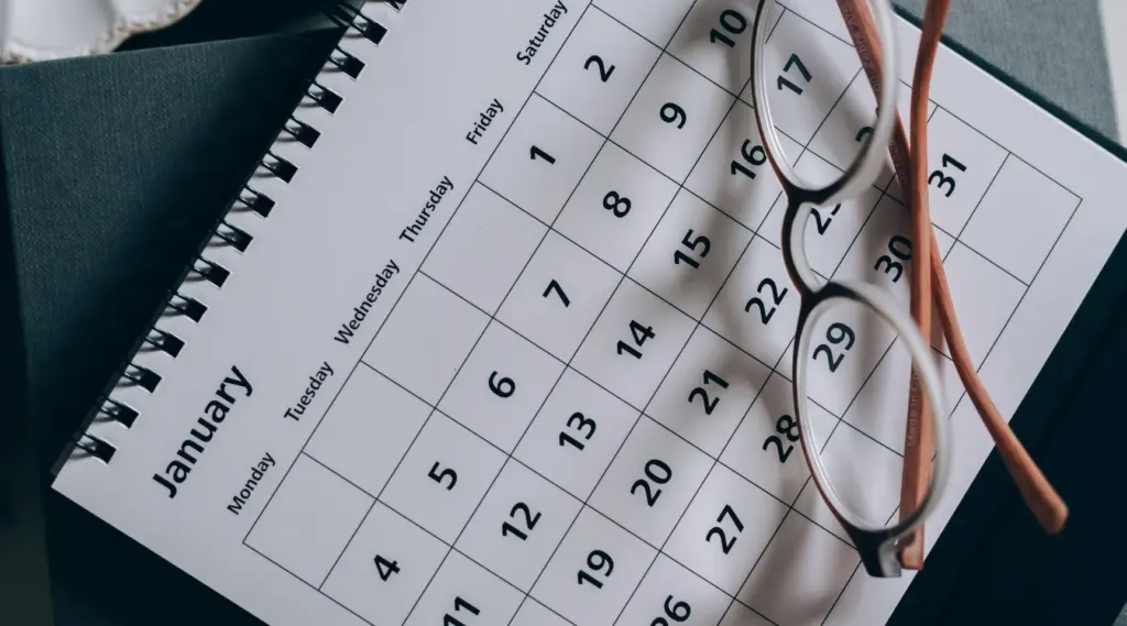 January calendar and glasses symbolizing care scheduling and planning with ShiftCare software.