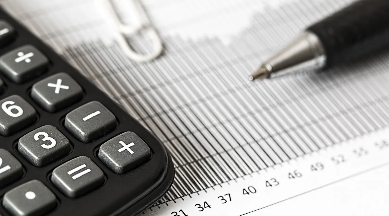Financial workspace showing calculator, pen, and sheet, ShiftCare.