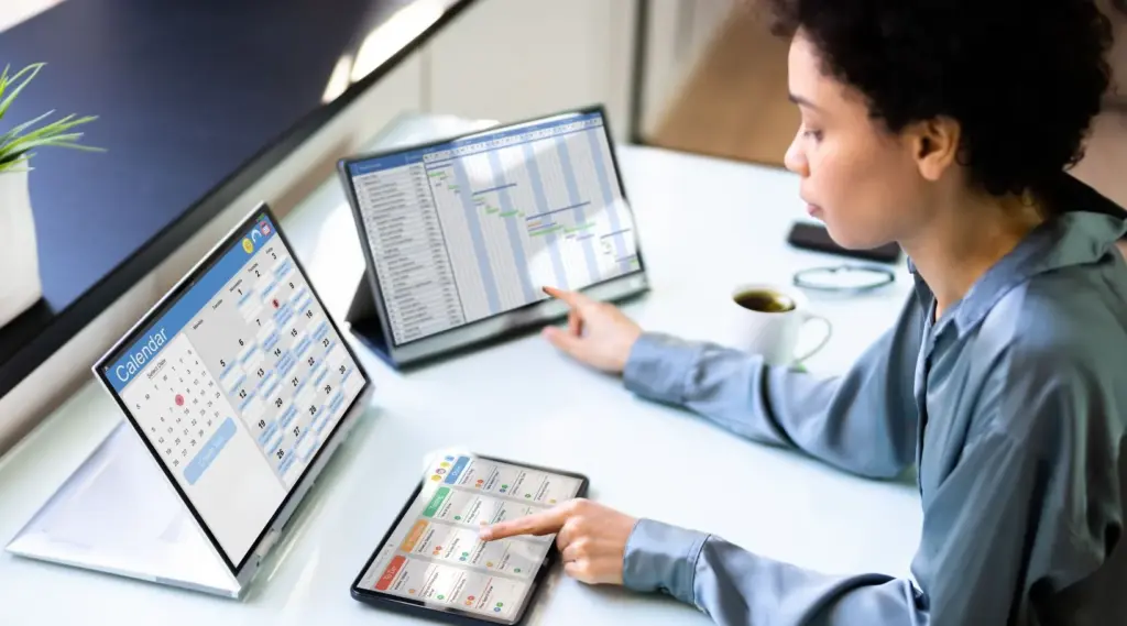 Care coordinator managing caregiver schedules and client visits using ShiftCare home care software dashboard.
