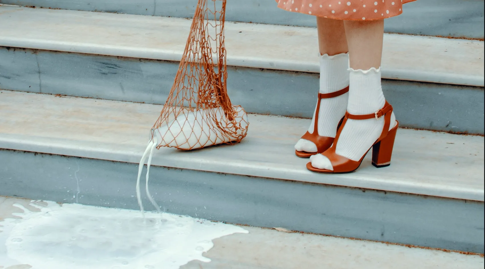 Spilled milk on stairs symbolizing accidental loss or missed opportunity.