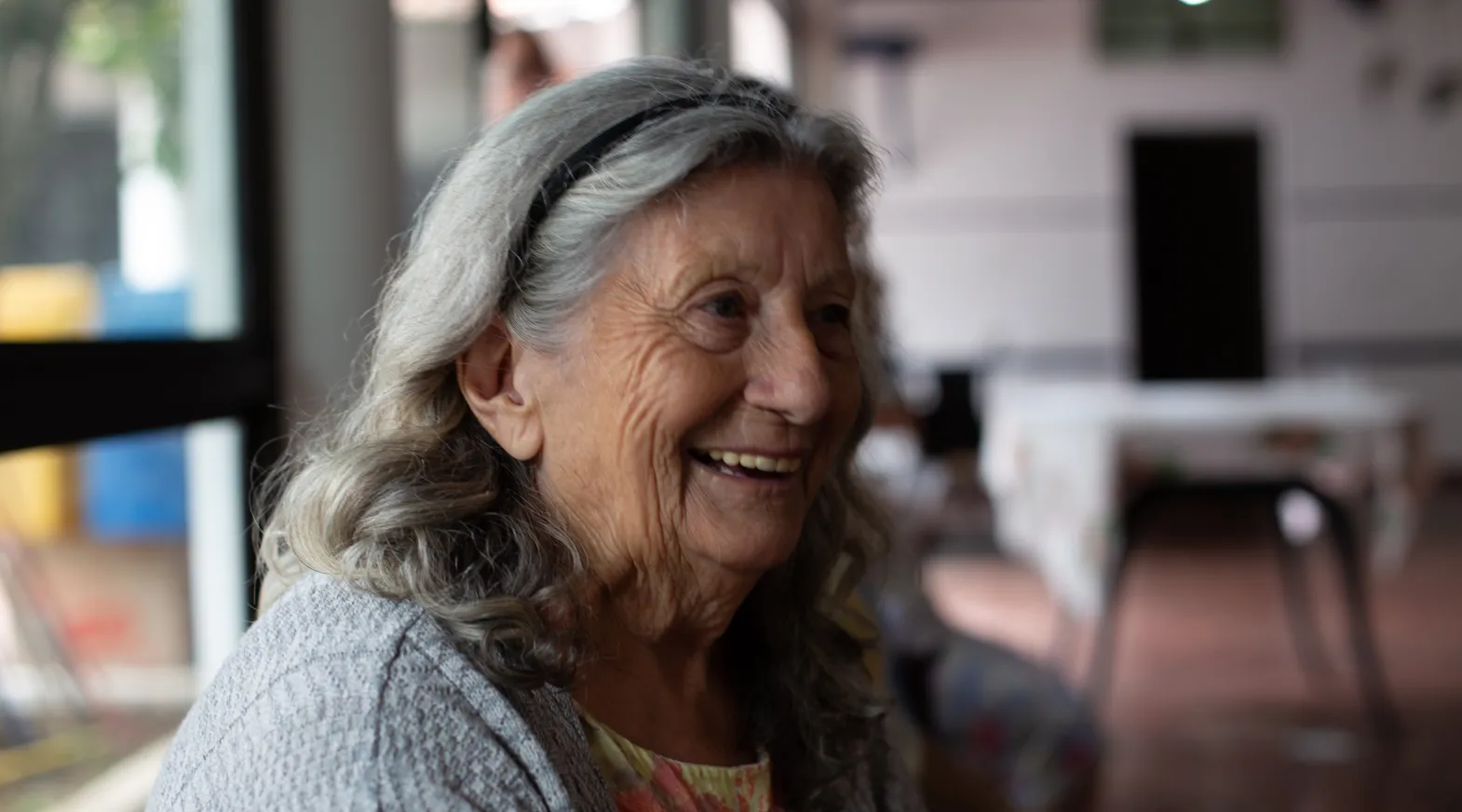 Elderly woman smiling warmly during a ShiftCare-supported home care visit session.