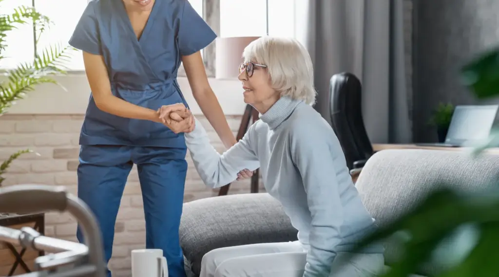 Caregiver assisting an elderly woman at home, showcasing ShiftCare’s home care management support.