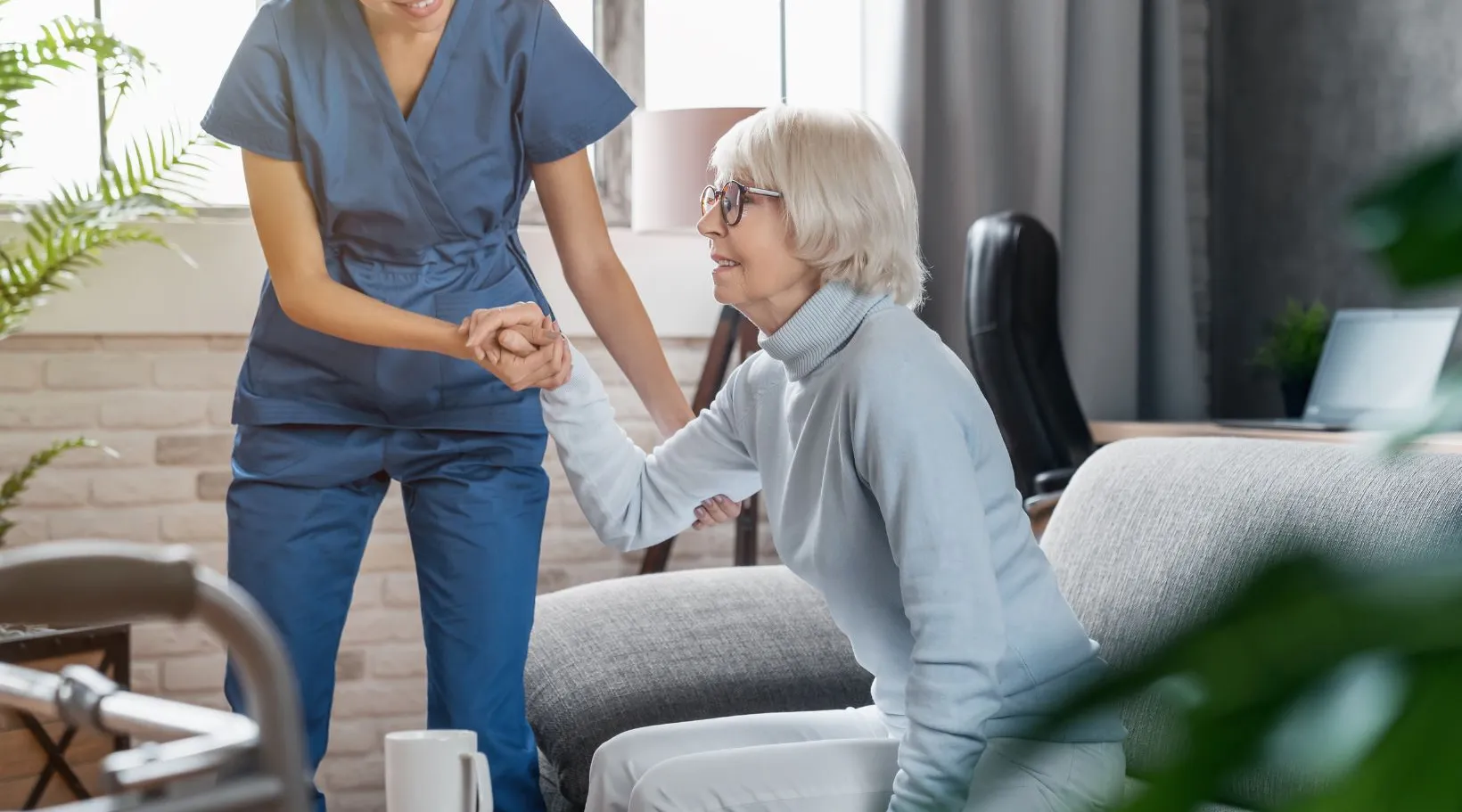 Caregiver assisting an elderly woman at home, showcasing ShiftCare’s home care management support.