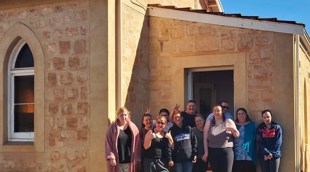 NDIS service users and staff enjoying a group activity at a disability support home in Australia.
