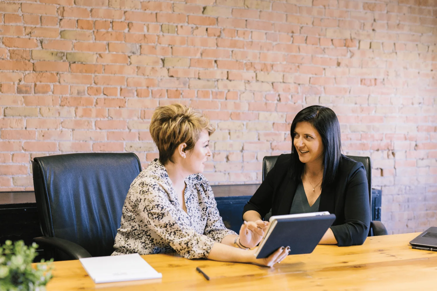 Professional meeting between two women in office, ShiftCare.