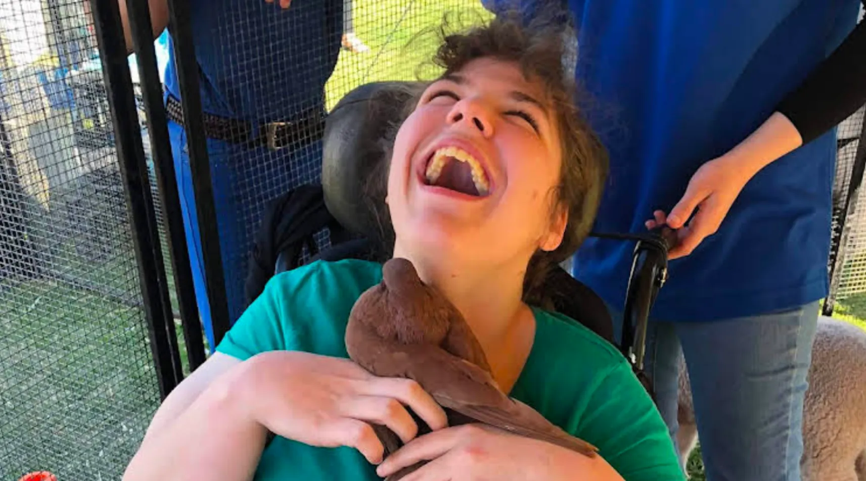 Disability support client enjoying animal-assisted therapy, ShiftCare.