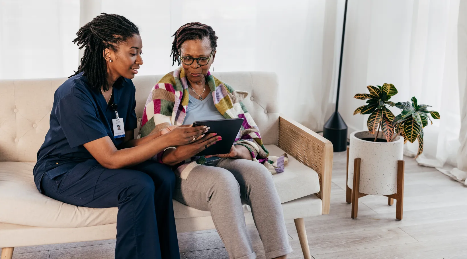 ShiftCare caregiver assisting client with online care records.